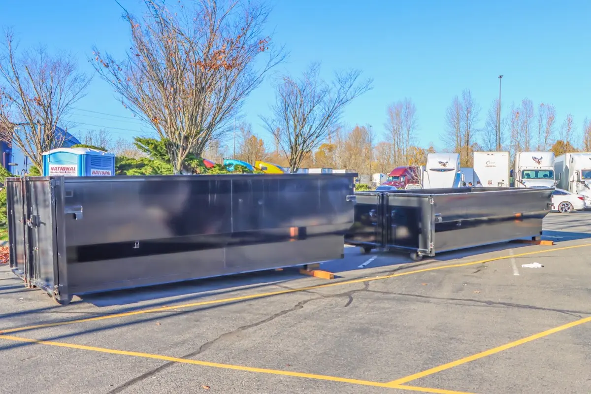 Professional dumpster rental service with roll-off container on residential driveway in Great Falls